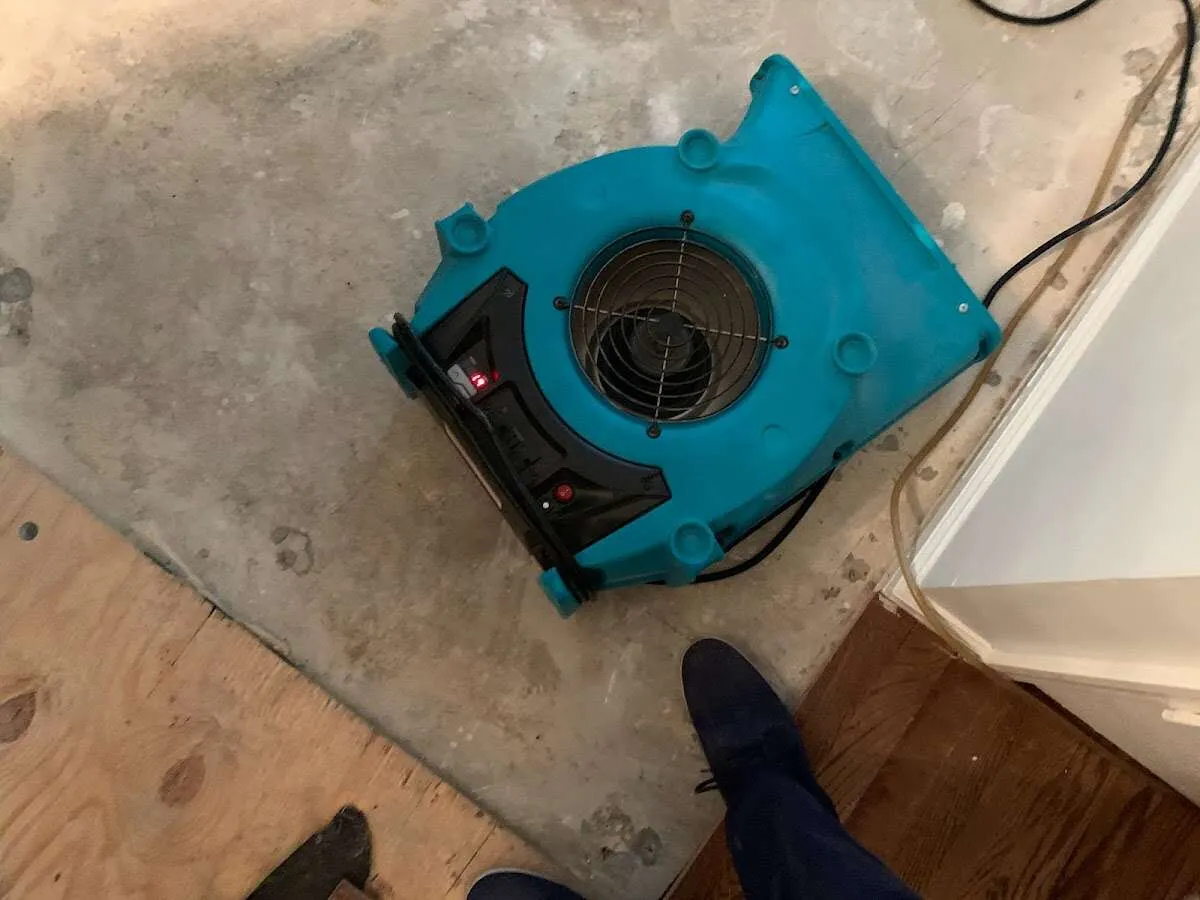 Air mover drying subfloor during Commercial Water Damage Restoration in Binghamton